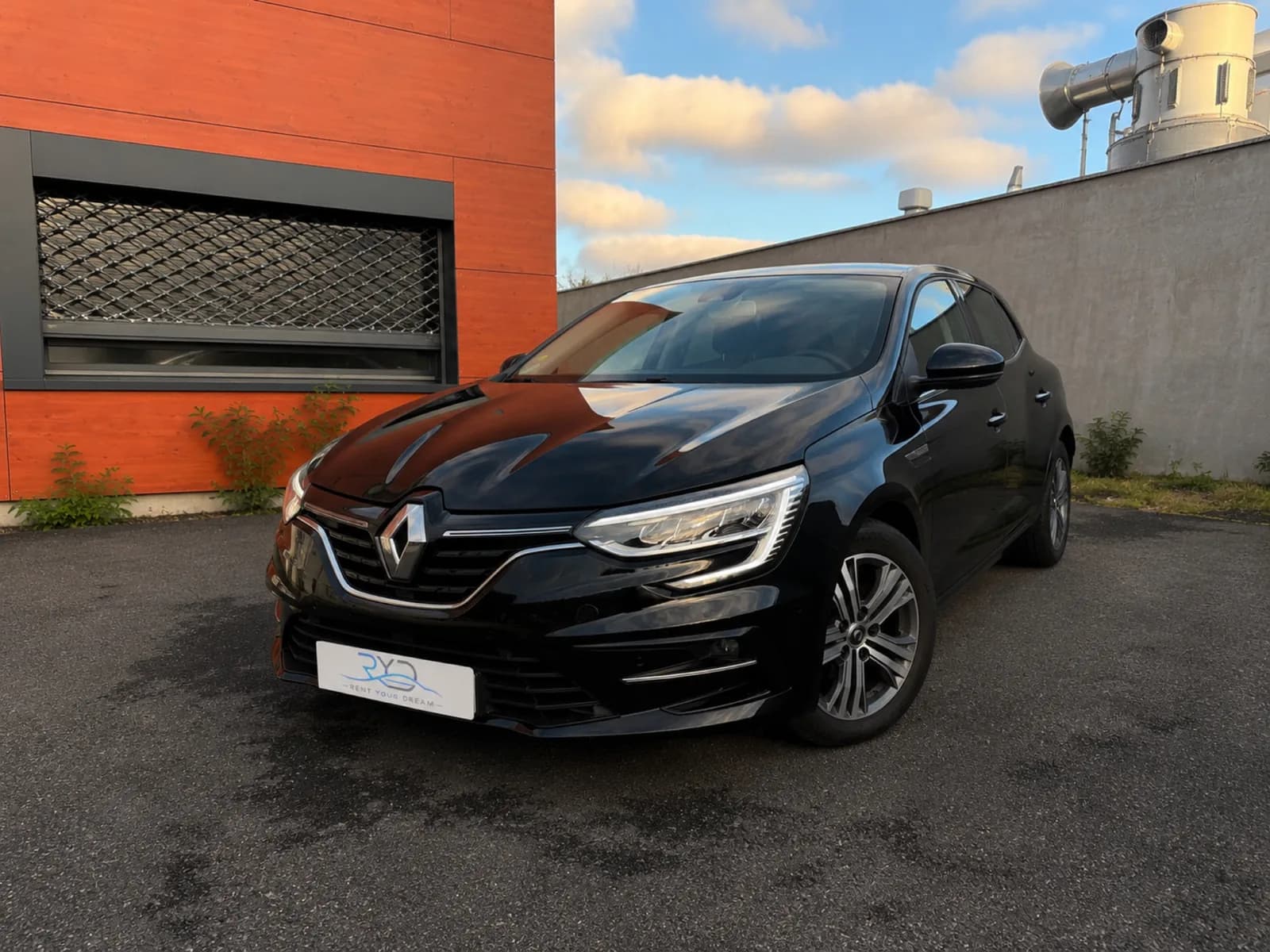 Black Rent Your Dream Renault Mégane 4, front three-quarter view