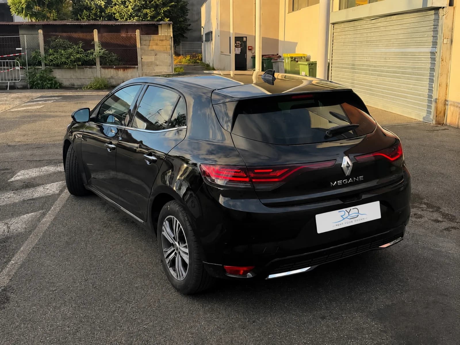 Black Rent Your Dream Renault Mégane 4, rear three-quarter view